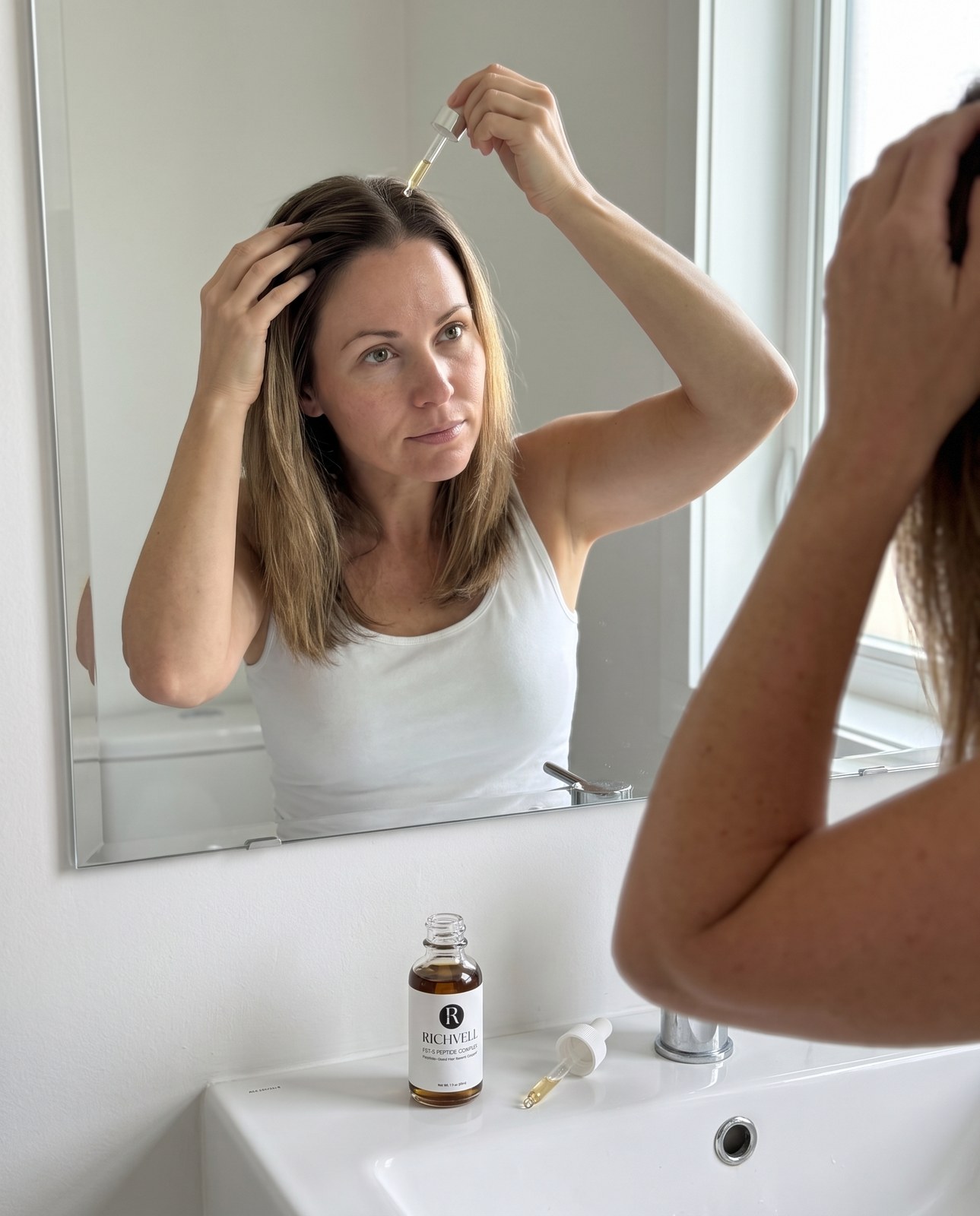 Woman applying FST-5 along her part line